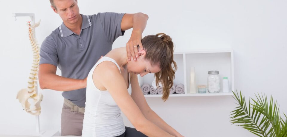 Doctor doing neck adjustment in medical office